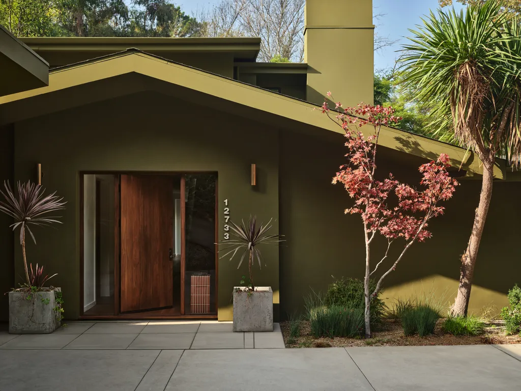 Mid-century modern home with fresh olive green exterior repaint and wood front door