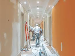 Painters working in a hallway of a multi-unit apartment complex during interior repaint