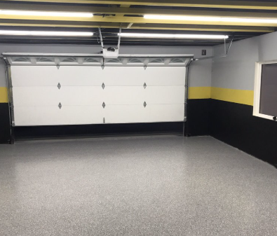 Epoxy coated garage floor with yellow accent stripe